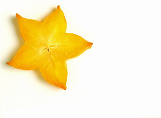 Fototapeta premium Closed up orange yellow sliced ripe Star Fruit on white background, with free space for text and design 