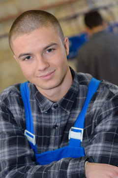 Portrait of young male worker wearing dungarees