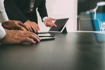co working team meeting concept,businessman using smart phone and digital tablet and laptop computer in modern office with glass reflected view