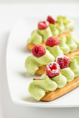 Eclaire with pistachio cream and strawberries