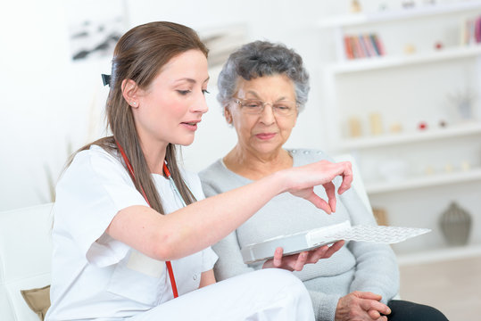 Nurse Discussing Medication With Elderly Woman