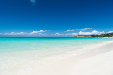 Fototapeta na wymiar Beach with white sand, turquoise sea and blue sky