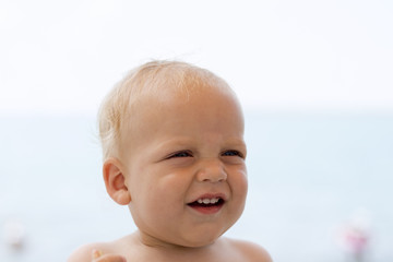 Fototapeta na wymiar Cute smiling baby boy on the beach