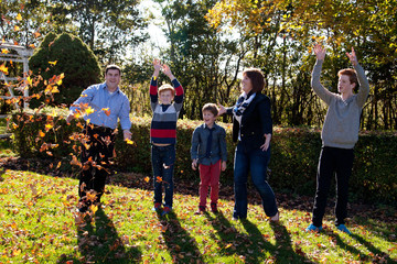 family plays outside in autumn 