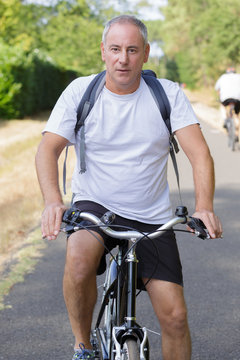 Portrait of middle aged man on bicycle