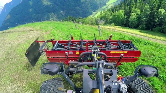 A tractor and agricultural machinery which is connected to it drive forward and then backwards. 