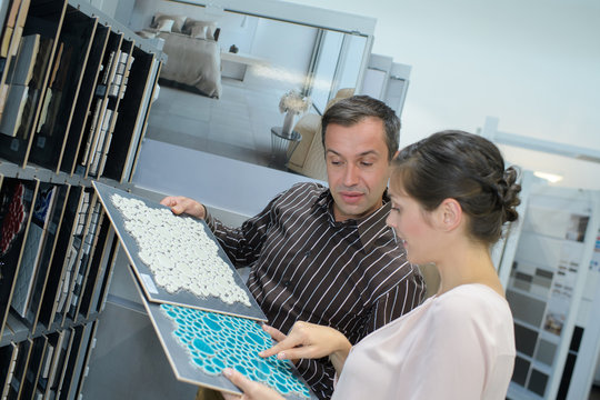 Man and woman looking at tile samples