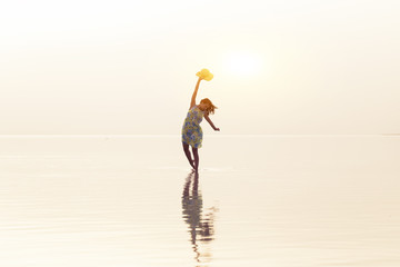 Woman walking at sea at sunset. Beach Summer Holiday Vacation Traveling Relaxation Concept 