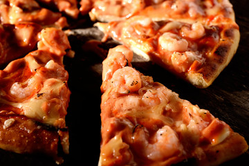 Pizza with shrimps on a wooden background