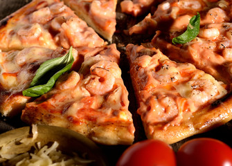 Pizza with shrimps on a wooden background