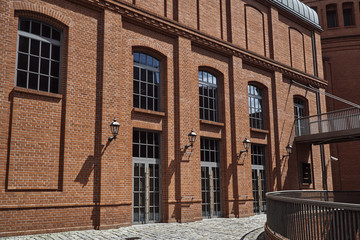 The metal railing and brick wall in an old brewery in Poznan. © GKor