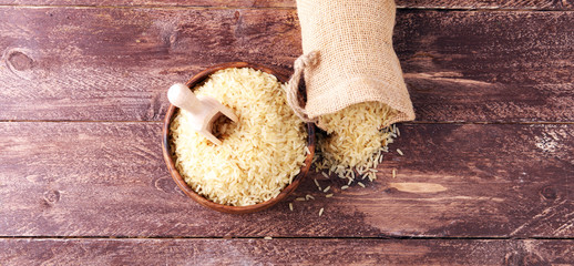 rice, indian basmati, pakistani basmati uncooked on brown background
