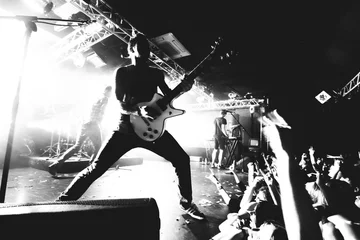 Fotobehang Guitarist on a stage, black and white © kondrukhov