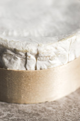 Rustic French ingredients. Close-up with Camembert cheese on wooden box