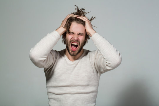 shouting or yawning man with long uncombed hair, morning, headache
