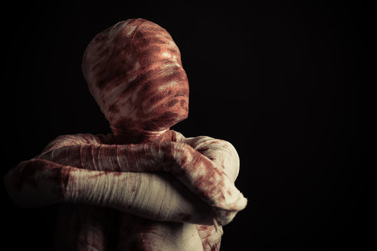 Frightening blood spattered mummy looks left