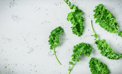 Fresh wet green kale leaves on grey background