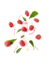Ripe raspberries, mint leaves and jam drops on a white background.