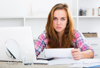 girl in trouble with laptop at table