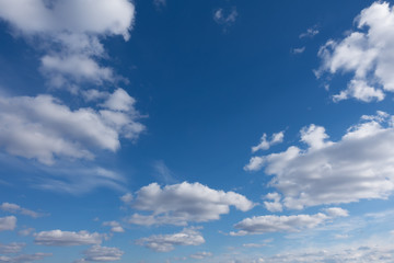 Beautiful clouds flying against blue sky at sunny day. Blue sky with clouds over horizon.
