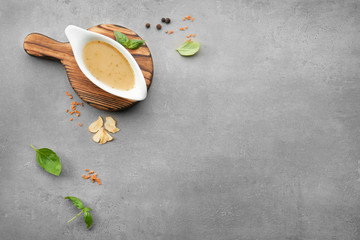Sauce boat with turkey gravy and spices on table