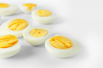 Sliced hard boiled eggs on white background. Nutrition concept