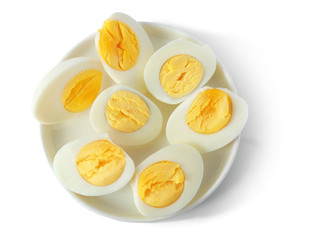 Ceramic tray with sliced hard boiled eggs on white background. Nutrition concept
