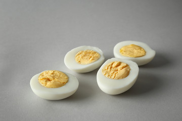 Sliced hard boiled eggs on grey background. Nutrition concept