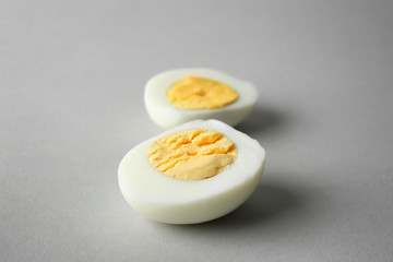 Sliced hard boiled egg on grey background. Nutrition concept