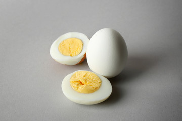 Hard boiled eggs on grey background. Nutrition concept