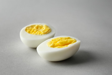 Sliced hard boiled egg on grey background. Nutrition concept