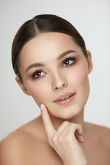 Woman Skin Beauty. Girl With Natural Makeup Touching Skin