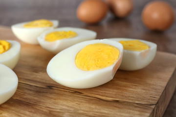Cutting board with sliced hard boiled eggs, closeup. Nutrition concept