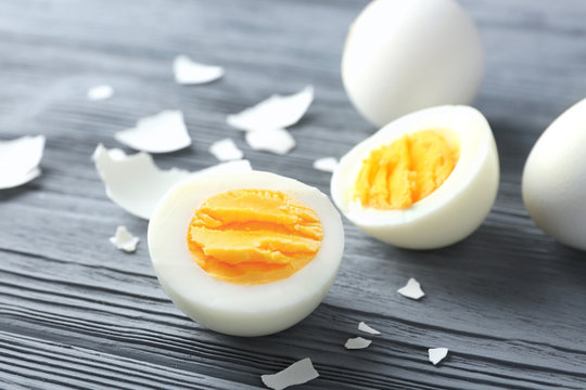 Sliced hard boiled egg on wooden surface. Nutrition concept