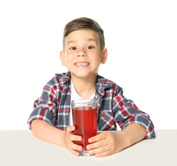 Cute little boy with glass of juice on white background © Africa Studio
