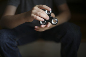 Little Boy Playing with a Fidget Spinner
