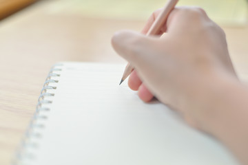 Blurred hand writing on notebook.