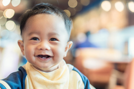 Close up Asian baby face smiling 9 months old.