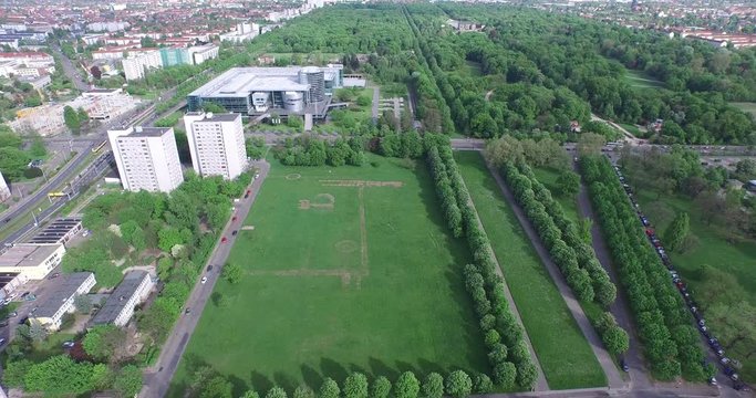 Drone view over famous car manufactory so called "Gl&radic;&sect;serne Manufaktur", aerial over the green garden of the city Dresden, Germany