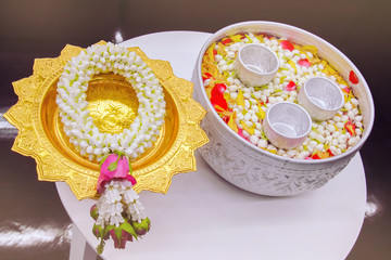 jasmine garland and jasmine and rose leaf in bowl for bless adults, Thai traditional for Mother's day and Father's day in thailand.