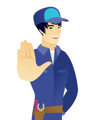 Young asian mechanic showing palm hand.