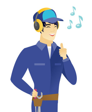 Asian Mechanic Listening To Music In Headphones.