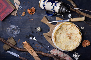 Top view of a rusty table with pancakes, hunters hut vintage style.