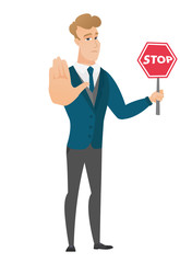 Caucasian groom holding stop road sign.