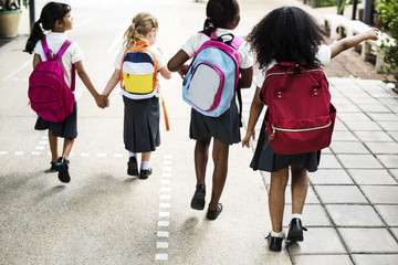 Group of diverse kindergarten students walking together - obrazy, fototapety, plakaty