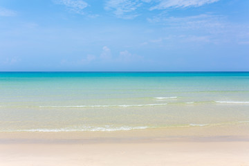 Fototapeta na wymiar Tropical white sand beach with turquoise water under blue sky. Paradise background