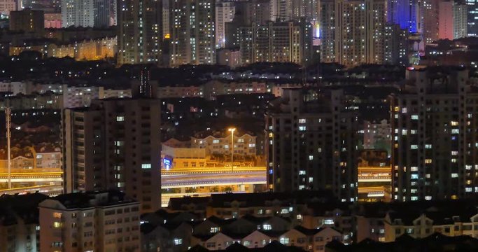 4k timelapse busy urban traffic jam highway at night,Overpass interchange,urban morden building,QingDao china.