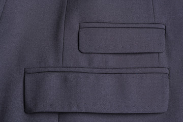 Two pockets of a black business jacket