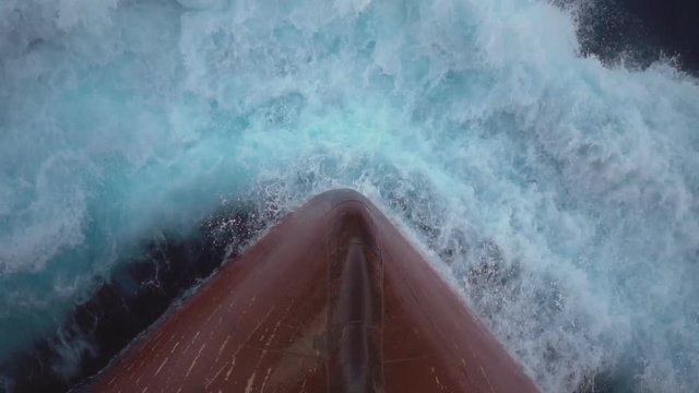 Foamy splashes of a sea wave against ship's bow - slow motion.