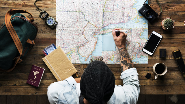 Aerial View Of Man Planning The Trip With Map